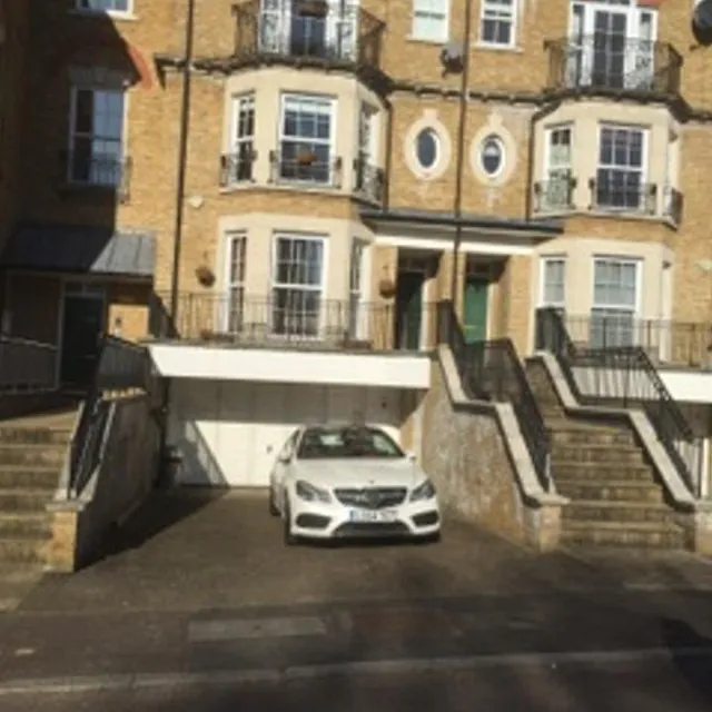 luxury home with vehicle out front